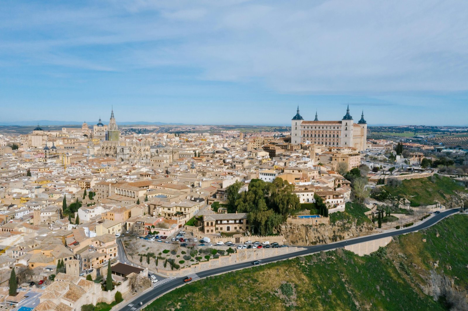 Stunning aerial view of Toledo, Spain featuring the Alcazar and historical architecture.